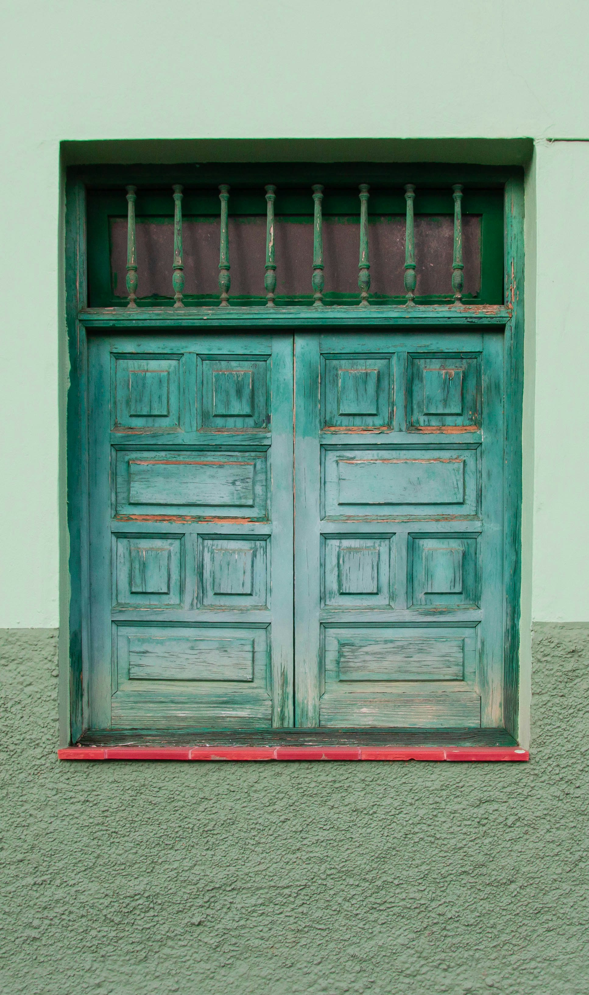 brown wooden door on white wall